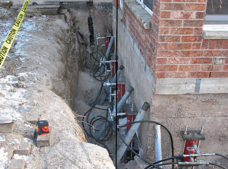 Foundation pier system installation in Kyle, Texas - steel piers being installed to stabilize a residential foundation